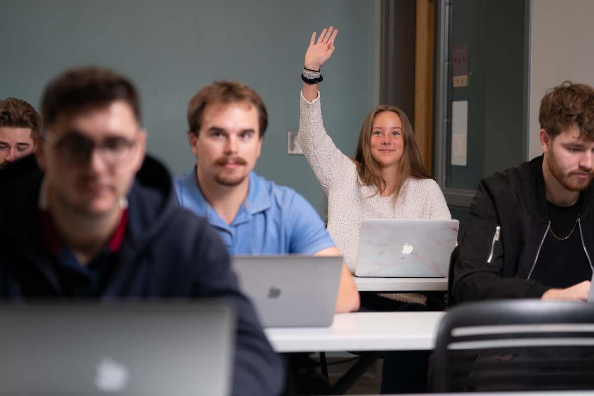 Student raising hand in class